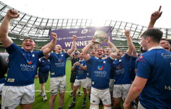 Ethan Baxter holds the trophy aloft as the St. Mary's players celebrate