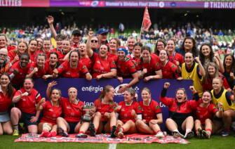 The UL Bohemian players and coaches celebrate with the league trophy